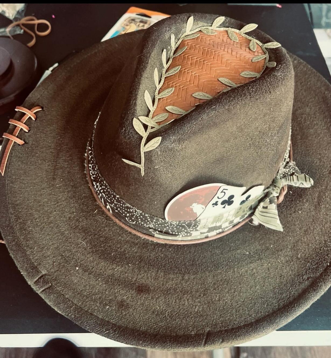 Distressed Dark Green Hat with brown & green band, leather topper, cards & feathers.